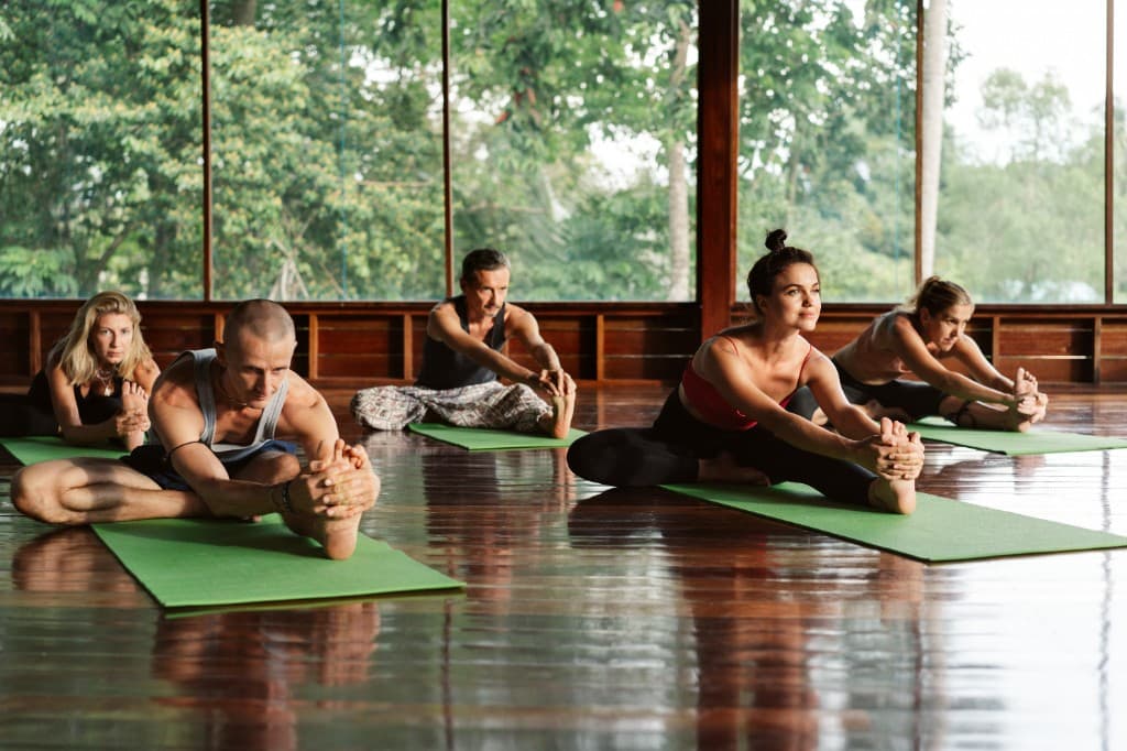 Group practicing yoga in a sunlit studio