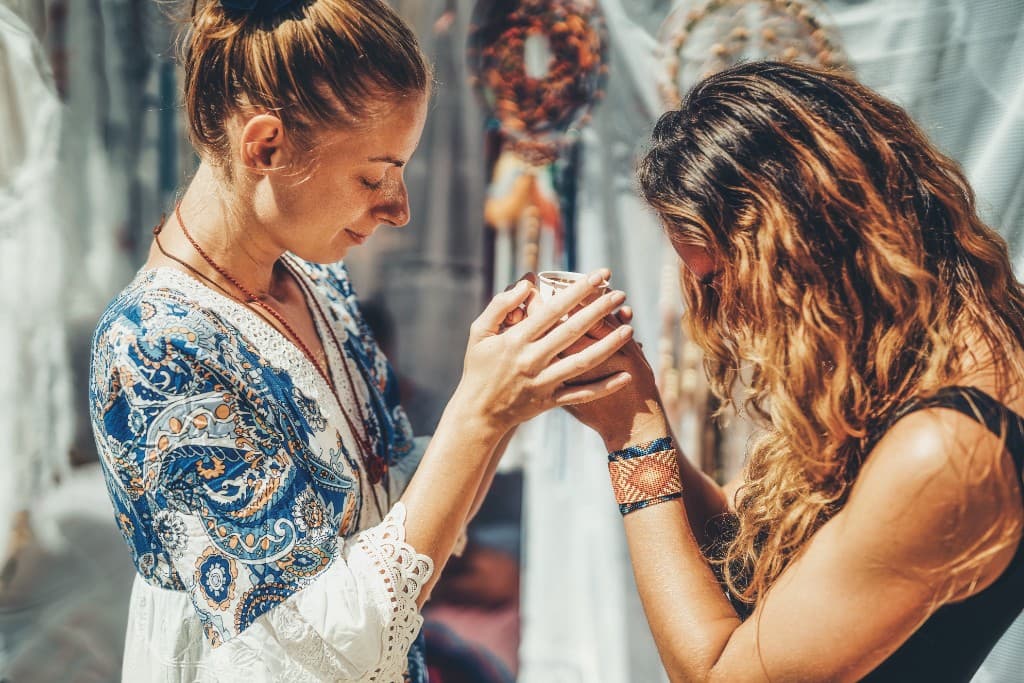 Two women sharing a cup in a moment of connection
